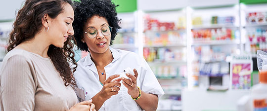 Female pharmacist helping female customer.